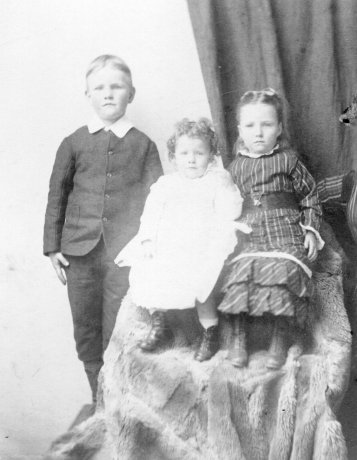 Jack Oliver with his sisters Mary (centre) and Lucy, c.1895.