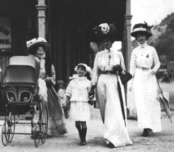 Alice Bell, far right. Left to right: her sister-in-law Annie Isabella (Ethel) Bell is pushing the pram, her youngest sister Agnes Mary Lipscombe Bell, holding the hand of her mother Alice Emma Bell. The photo was taken in Greymouth in 1909. The elaborate clothing would most likely have been made by Alice.